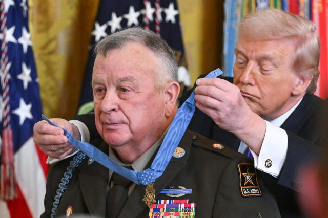 US President Donald Trump awards the Medal of Honor to retired Army Command Sgt. Major Terry P. Richardson during a ceremony in the East Room of the White House on March 2, 2026, in Washington, DC. President Trump awarded the Medal of Honor to retired Army Command Sgt. Major Terry P. Richardson, who served in the Vietnam War, posthumously to Army Master Sgt. Roderick W. Edmonds, who served in World War II, and posthumously to Staff Sgt. Michael Ollis, who died in combat in Afghanistan in 2013. (Photo by SAUL LOEB / AFP)
