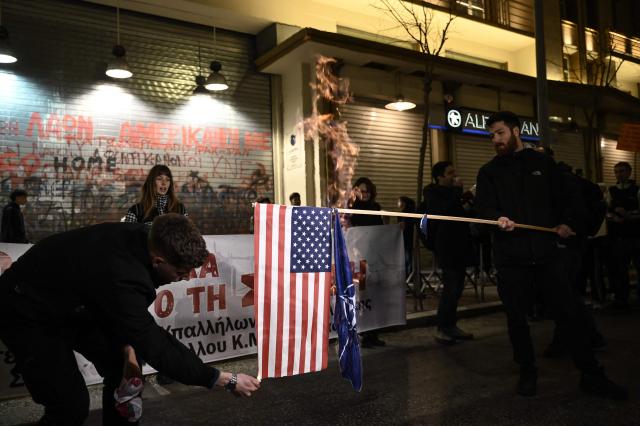 Demonstrators burns a US and a NATO flag as they take part in a rally condemning the US-Israeli strikes on Iran in Thessaloniki on March 2, 2026. Iranian state television confirmed the death of Iran's supreme leader Ayatollah Ali Khamenei on February 28, 2026, after the US president said he had been killed. The announcement came after the United States and Israel started launching waves of strikes against targets in Iran, sparking swift retaliation by the Islamic republic. (Photo by Sakis Mitrolidis / AFP)
