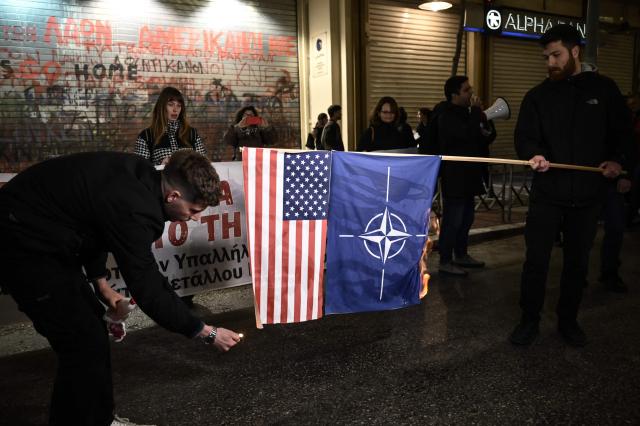 Demonstrators burn a US and a NATO flag as they take part in a rally condemning the US-Israeli strikes on Iran in Thessaloniki on March 2, 2026. Iranian state television confirmed the death of Iran's supreme leader Ayatollah Ali Khamenei on February 28, 2026, after the US president said he had been killed. The announcement came after the United States and Israel started launching waves of strikes against targets in Iran, sparking swift retaliation by the Islamic republic. (Photo by Sakis Mitrolidis / AFP)