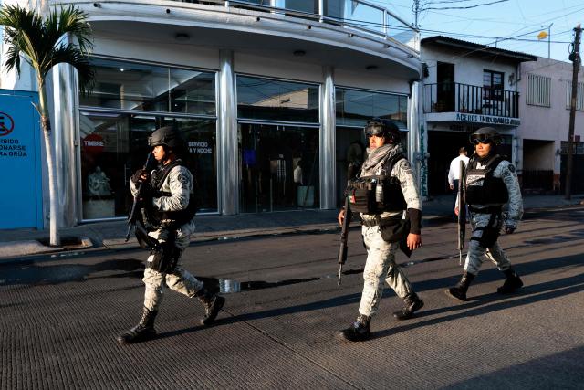 Army soldiers patrol outside La Paz funeral home, during the wake of drug trafficker Nemesio "El Mencho" Oseguera in Guadalajara, Jalisco state, Mexico, on March 2, 2026. Mexican soldiers watched over the funeral of Oseguera, who died on February 22 during a military operation. (Photo by Ulises Ruiz / AFP)