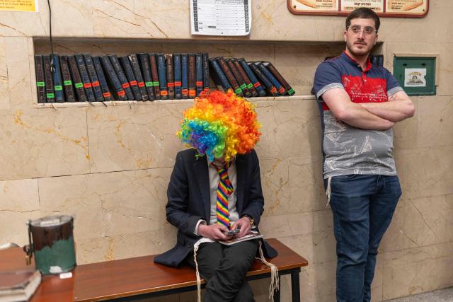 Orthodox Jews gather in a Yeshiva as they celebrate the carnival-like Purim holiday in Bnei-Brak on March 2, 2026. The United States and Israel launched strikes against Iran on February 28, killing Iran's supreme leader and top military leaders, prompting authorities to retaliate with strikes on Israel and across the Gulf. (Photo by Ilia YEFIMOVICH / AFP)