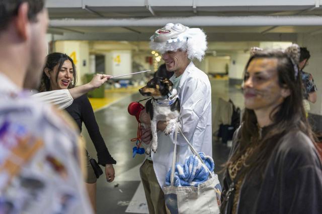Israelis dressed in costumes gather in a parking lot used as a shelter to celebrate the carnival-like Purim holiday in Tel-Aviv on March 2, 2026. The United States and Israel launched strikes against Iran on February 28, killing Iran's supreme leader and top military leaders, prompting authorities to retaliate with strikes on Israel and across the Gulf. (Photo by Ilia YEFIMOVICH / AFP)