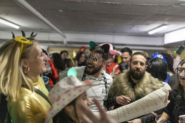 Israelis dressed in costumes gather in a parking lot used as a shelter to celebrate the carnival-like Purim holiday in Tel-Aviv on March 2, 2026. The United States and Israel launched strikes against Iran on February 28, killing Iran's supreme leader and top military leaders, prompting authorities to retaliate with strikes on Israel and across the Gulf. (Photo by Ilia YEFIMOVICH / AFP)