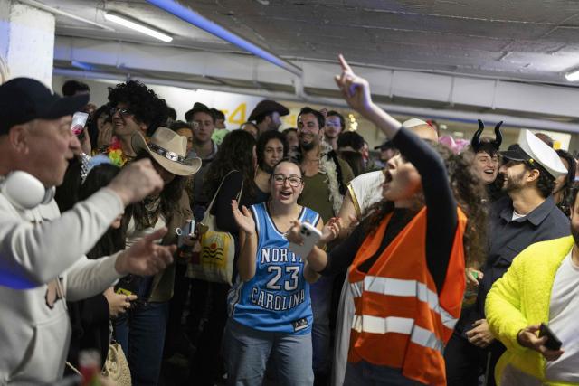 Israelis dressed in costumes gather in a parking lot used as a shelter to celebrate the carnival-like Purim holiday in Tel-Aviv on March 2, 2026. The United States and Israel launched strikes against Iran on February 28, killing Iran's supreme leader and top military leaders, prompting authorities to retaliate with strikes on Israel and across the Gulf. (Photo by Ilia YEFIMOVICH / AFP)