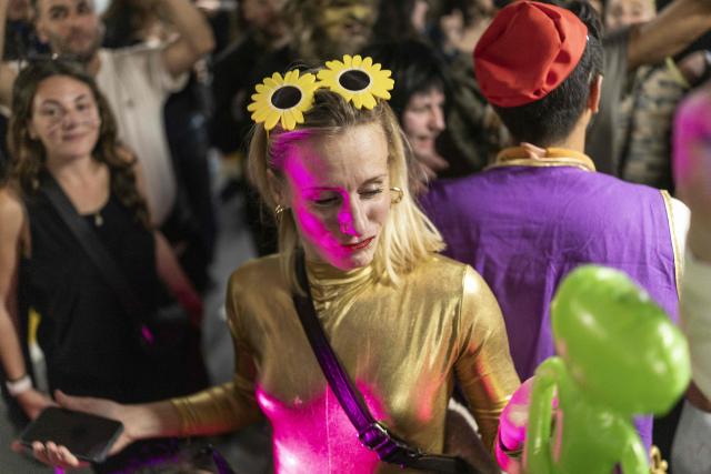 Israelis dressed in costumes gather in a parking lot used as a shelter to celebrate the carnival-like Purim holiday in Tel-Aviv on March 2, 2026. The United States and Israel launched strikes against Iran on February 28, killing Iran's supreme leader and top military leaders, prompting authorities to retaliate with strikes on Israel and across the Gulf. (Photo by Ilia YEFIMOVICH / AFP)