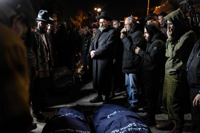 TOPSHOT - Mourners attend the funeral of Yaakov Biton, 16, and his two sisters Avigail, 15, and Sarah, 13, who were killed the previous day in an Iranian attack, at a cemetery on the Mount of Olives in Jerusalem on March 2, 2026. The United States and Israel launched strikes against Iran on February 28, killing Iran's supreme leader and top military leaders, prompting authorities to retaliate with strikes on Israel and across the Gulf. (Photo by JOHN WESSELS / AFP)
