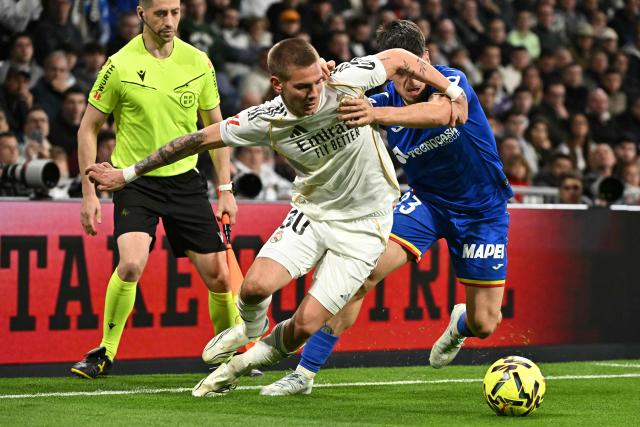 Real Madrid's Argentinian midfielder #30 Franco Mastuantono and Getafe's Spanish forward #23 Adrian Liso fight for the ball during the Spanish league football match between Real Madrid CF and Getafe CF at Santiago Bernabeu Stadium in Madrid on March 2, 2026. (Photo by Javier SORIANO / AFP)