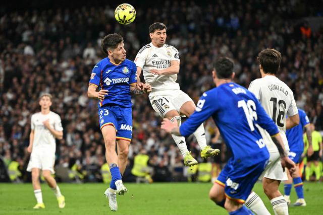 Getafe's Spanish forward #23 Adrian Liso and Real Madrid's Moroccan forward #21 Brahim Diaz vie for a header during the Spanish league football match between Real Madrid CF and Getafe CF at Santiago Bernabeu Stadium in Madrid on March 2, 2026. (Photo by Javier SORIANO / AFP)