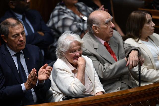 Uruguay's Economy Minister Gabriel Oddone (L), Uruguay's former vice president Lucia Topolansky (2nd L), widow of former president Jose Mujica, and former president Julio Maria Sanguinetti (2nd R) attend President Yamandu Orsi's speech before the General Assembly at the Legislative Palace in Montevideo on March 2, 2026, marking Orsi's first year in office. (Photo by EITAN ABRAMOVICH / AFP)