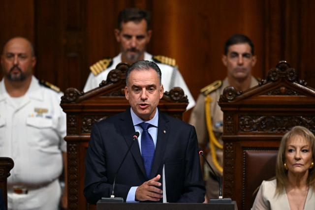 Uruguay's President Yamandu Orsi delivers a speech before the General Assembly next to Uruguay's Vice President Carolina Cosse (R) at the Legislative Palace in Montevideo on March 2, 2026, marking his first year in office. (Photo by EITAN ABRAMOVICH / AFP)
