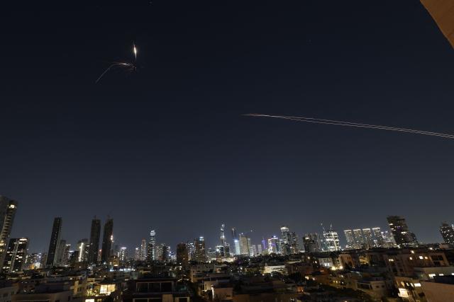 Rocket trails are seen in the sky amid a fresh barrage of Iranian missile attacks above the Israeli coastal city of Tel Aviv on March 3, 2026. (Photo by Jack GUEZ / AFP)