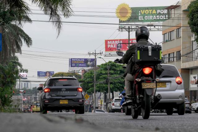 Vehicles drive along an avenue lined with multiple electoral billboards in Cali, Colombia, on March 2, 2026. Colombia will hold legislative elections on March 8, 2026, and a presidential election on May 31. (Photo by JOAQUIN SARMIENTO / AFP)