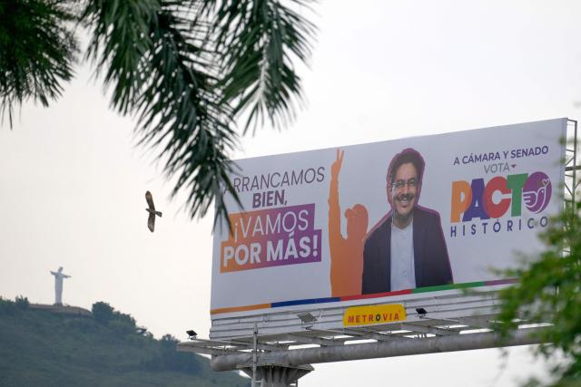 An electoral billboard for Colombia's presidential candidate Ivan Cepeda, who is running for the Pacto Historico party, is displayed along a roadway in Cali, Colombia, on March 2, 2026. Colombia will hold legislative elections on March 8, 2026, and a presidential election on May 31. (Photo by JOAQUIN SARMIENTO / AFP)