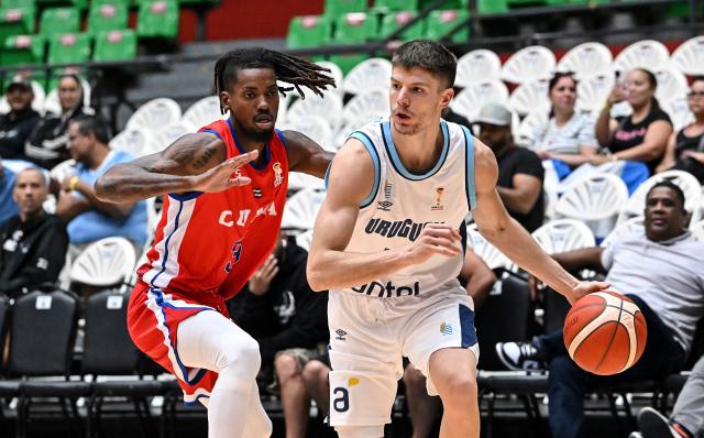 Uruguay's Joaquin Rodriguez (R) dribbles against Cuba's Ibrahin Hechavarria during the FIBA Basketball World Cup 2027 Americas qualifiers match between Cuba and Uruguay at the Arena Roberto Duran in Panama City on March 2,2026. (Photo by MARTIN BERNETTI / AFP)
