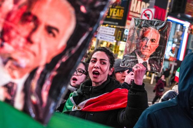 A woman holds a portrait of Reza Pahlavi, son of the last shah of Iran, during a "Freedom for Iran" protest in support of the Iranian people in New York on March 2, 2026. The United States hit hundreds of targets across Iran, and Israel expanded its bombing to Lebanon on Monday as President Donald Trump vowed to avenge the first US deaths in the war he launched to topple Tehran's ruling clerics. Iranian forces fired missiles and drones across the Middle East, killing people in Israel and the United Arab Emirates, in retaliation for the conflict that began February 28 with the death of Iran's supreme leader, Ayatollah Ali Khamenei. (Photo by Ryan MURPHY / AFP)