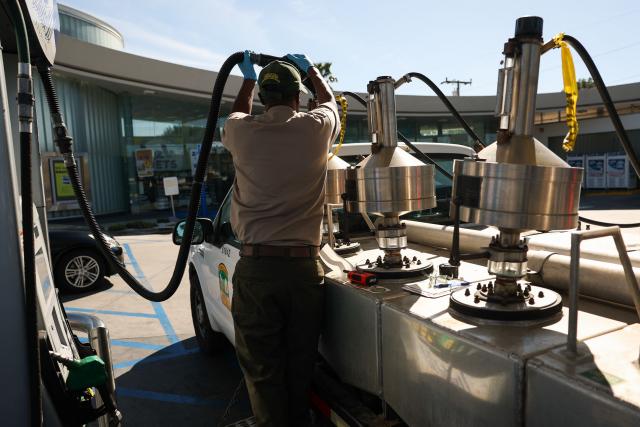 An inspector with the Los Angeles County Agricultural Commissioner tests a gasoline fuel pump at a gas station in Los Angeles, California on March 2, 2026. Energy prices surged on March 2 as the war in the Middle East led to outages of key energy production operations. In parallel, energy markets are also absorbing a de facto halt to traffic in the Strait of Hormuz, through which about 20 percent of global supply of oil and liquid natural gas travel.

The waterway has not technically been closed, but major maritime companies have suspended travel through it as insurance costs soar amid heightened risk. (Photo by Patrick T. Fallon / AFP)
