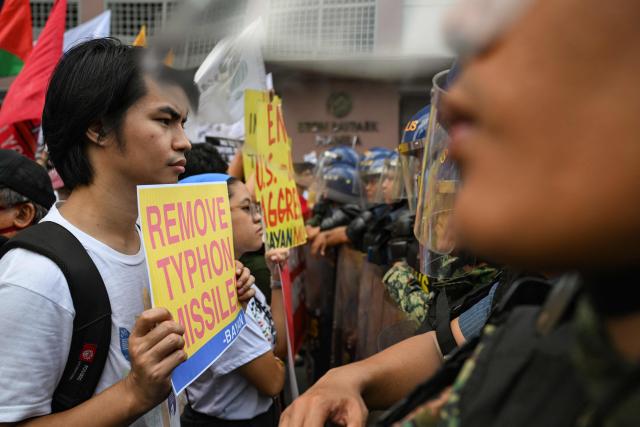 Activists hold placards during a rally condemning the US-Israeli strikes on Iran, near the US embassy in Manila on March 3, 2026. (Photo by Jam STA ROSA / AFP)