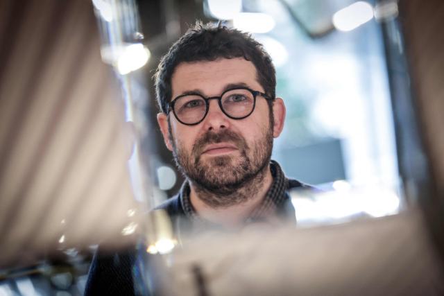 French illustrator and writer Mathieu Persan poses during a photo session in Paris on February 25, 2026. "How is it that on a starry night, she sees nothing but infinite darkness?" wonders illustrator Mathieu Persan in a powerful graphic novel, "Le Passage", which recounts his 15-year-old daughter's deep depression and pays tribute to the many children in France who "are not doing well". On the cover, two small figures walk under a starry sky towards a distant point of light. Published on March 11, 2026 by Hachette, it is a story without pathos, in which the voice of a teenage girl responds to that of her father, a graphic novel with minimalist black and white illustrations, full of fantasy and humour, despite its serious subject matter. (Photo by STEPHANE DE SAKUTIN / AFP)