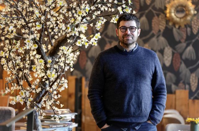 French illustrator and writer Mathieu Persan poses during a photo session in Paris on February 25, 2026. "How is it that on a starry night, she sees nothing but infinite darkness?" wonders illustrator Mathieu Persan in a powerful graphic novel, "Le Passage", which recounts his 15-year-old daughter's deep depression and pays tribute to the many children in France who "are not doing well". On the cover, two small figures walk under a starry sky towards a distant point of light. Published on March 11, 2026 by Hachette, it is a story without pathos, in which the voice of a teenage girl responds to that of her father, a graphic novel with minimalist black and white illustrations, full of fantasy and humour, despite its serious subject matter. (Photo by STEPHANE DE SAKUTIN / AFP)