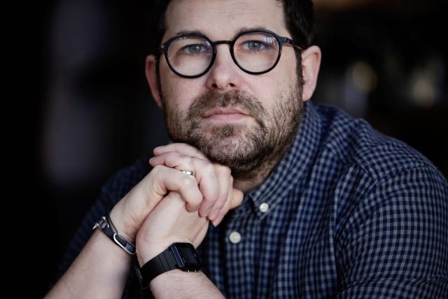 French illustrator and writer Mathieu Persan poses during a photo session in Paris on February 25, 2026. "How is it that on a starry night, she sees nothing but infinite darkness?" wonders illustrator Mathieu Persan in a powerful graphic novel, "Le Passage", which recounts his 15-year-old daughter's deep depression and pays tribute to the many children in France who "are not doing well". On the cover, two small figures walk under a starry sky towards a distant point of light. Published on March 11, 2026 by Hachette, it is a story without pathos, in which the voice of a teenage girl responds to that of her father, a graphic novel with minimalist black and white illustrations, full of fantasy and humour, despite its serious subject matter. (Photo by STEPHANE DE SAKUTIN / AFP)