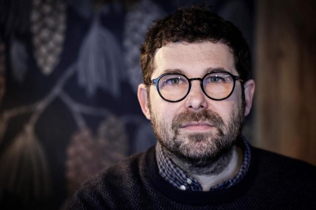 French illustrator and writer Mathieu Persan poses during a photo session in Paris on February 25, 2026. "How is it that on a starry night, she sees nothing but infinite darkness?" wonders illustrator Mathieu Persan in a powerful graphic novel, "Le Passage", which recounts his 15-year-old daughter's deep depression and pays tribute to the many children in France who "are not doing well". On the cover, two small figures walk under a starry sky towards a distant point of light. Published on March 11, 2026 by Hachette, it is a story without pathos, in which the voice of a teenage girl responds to that of her father, a graphic novel with minimalist black and white illustrations, full of fantasy and humour, despite its serious subject matter. (Photo by STEPHANE DE SAKUTIN / AFP)