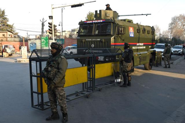Security personnel stand guard along a street in Srinagar on March 3, 2026 as authorities imposed restrictions across the region amid protests over the death of Iran's supreme leader Ayatollah Ali Khamenei by US-Israel strikes. (Photo by Habib NAQASH / AFP)