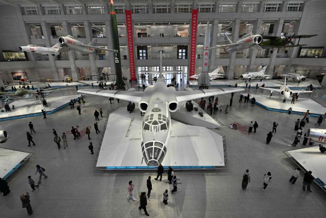 Visitors walk past Chinese People's Liberation Army Air Force aircraft on display the Military Museum in Beijing on March 3, 2026, ahead of the opening of the annual session of the National People’s Congress (NPC). (Photo by ADEK BERRY / AFP)
