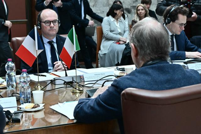 France's junior Minister for industry Sebastien Martin (L) listens to the Minister of Enterprises and Made in Italy Adolfo Urso (R, from behind) during a meeting at the Ministry of Enterprises and Made in Italy in Rome on March 3, 2026. (Photo by Filippo MONTEFORTE / AFP)