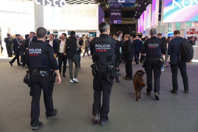 Mossos d'Esquadra (Catalan police) patrol during the Mobile World Congress (MWC), the world's biggest mobile technology showcase and fair in Barcelona on March 3, 2026. The Mobile World Congress (MWC), the major annual telecommunications event, opened in Barcelona for an edition where Artificial Intelligence in telecommunications will take center stage in the debates. The event, which marks its twentieth anniversary, will host the world's leading telecommunications operators and numerous manufacturers. 109,000 industry professionals and visitors are expected. (Photo by Josep LAGO / AFP)