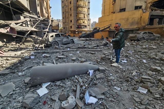 People inspect a site of an Israeli airstrike in the southern suburbs of Beirut on March 3, 2026. The war launched by the United States and Israel against Iran spread across the Middle East, threatening to plunge the global economy into chaos, with Lebanon and Gulf energy exporters dragged into the conflict. (Photo by AFP)