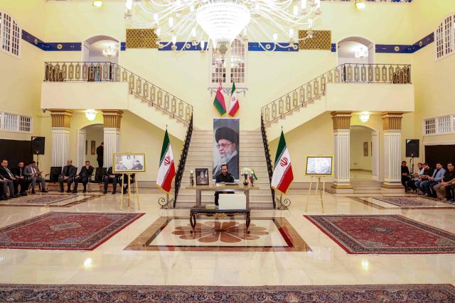 A man reads verses from the Koran, Islam's holy book, as mourners gather to pay their respects for Iran's slain supreme leader Ali Khamenei, who was was killed in a joint US-Israeli strike on Tehran on February 28, during a memorial service at the Iranian embassy headquarters in Oman's capital Muscat on March 3, 2026. The United States and Israel launched strikes against Iran on February 28, killing Iran's supreme leader and top military leaders, prompting authorities to retaliate with strikes on Israel and US bases across the Gulf. (Photo by Haitham AL-SHUKAIRI / AFP)
