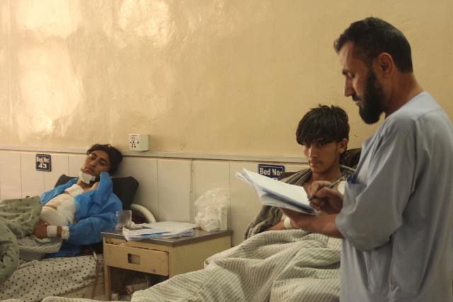 Wounded Afghan men receive medical treatment at a hospital in Jalalabad on March 3, 2026 amid ongoing cross-border conflict between Pakistan and Afghanistan. More than 8,000 Afghans have been forced from their homes by fighting with Pakistani forces along the border in recent days, the Taliban government said on March 3. (Photo by AFP)