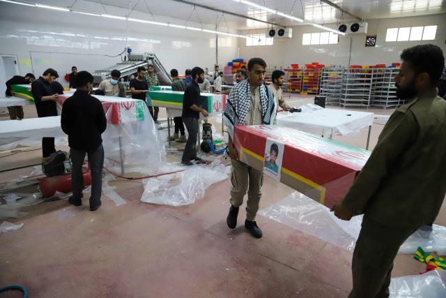 In this picture obtained from Iran's ISNA news agency, mourners prepare the coffins of children who were killed in a reported strike on a primary school in Irans Hormozgan province for a funeral in Minab on March 3, 2026. Iranian media have reported hundreds of Iranian casualties, including at a girl's school, although AFP reporters have not been able to verify tolls independently. The war launched by the United States and Israel against Iran spread across the Middle East, threatening to plunge the global economy into chaos, with Lebanon and Gulf energy exporters dragged into the conflict. (Photo by Amirhossein KHORGOOEI / ISNA / AFP)