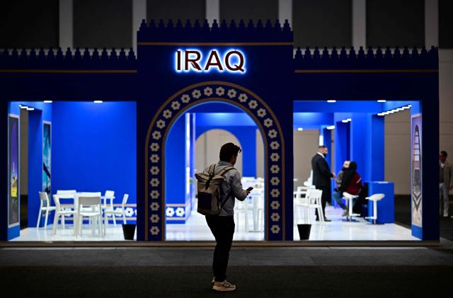 A man stands at the booth of Iraq on the opening day of the ITB (Internationale Tourismus-Boerse) tourism fair in Berlin on March 3, 2026. Around 190 countries are represented at the platform for the global travel and tourism industry running from March 3 to 5, 2026. (Photo by Tobias SCHWARZ / AFP)