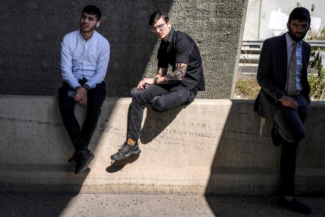 Men take shelter under a bridge after missile sirens sounded in Tel Aviv on March 3, 2026. The United States and Israel started striking Iran on February 28, killing Iran's supreme leader and top military leaders, and prompting authorities to retaliate with strikes on Israel and across the Gulf. (Photo by JOHN WESSELS / AFP)