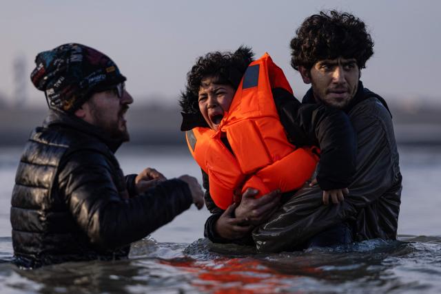 A child cries as his family boarded a smugglers' boat without him in an attempt to cross the English Channel off the beach of Gravelines, northern France, on March 3, 2026. At dawn on March 3, 2026, four makeshift boats left the beach at Gravelines, each carrying at least around fifty people, taking advantage of the temporary improvement in weather conditions to attempt an illegal crossing of the English Channel, AFP journalists observed. (Photo by Sameer Al-DOUMY / AFP)