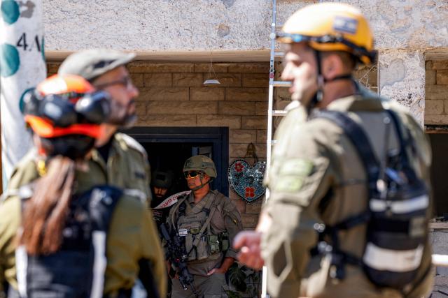 Israeli army and security forces conduct a search sweep of a house that was hit by Hezbollah projectiles in Moshav Kfar Yuval in northern Israel near the border with southern Lebanon on March 3, 2026. Israel on March 3 ordered the military to take control of more positions in Lebanon, where the army pulled back some of its forces after Hezbollah attacked Israeli bases in support of its backer, Iran. (Photo by Jalaa MAREY / AFP)