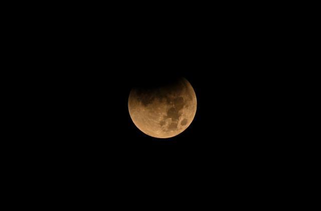 A full moon, also known as the "Blood Moon", rises over Panama City, on March 03, 2026, during a total lunar eclipse. (Photo by MARTIN BERNETTI / AFP)