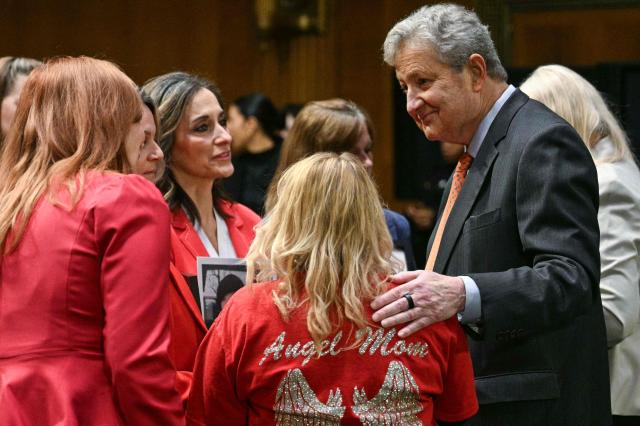 US Senator John Kennedy, Republican from Louisiana, speaks with a group of mothers who say they lost children to violence by undocumented immigrants, before US Homeland Security Secretary Kristi Noem arrives to testify during a Senate Judiciary Committee hearing on oversight of the Department of Homeland Security, on Capitol Hill in Washington, DC on March 3, 2026. (Photo by Jim WATSON / AFP)
