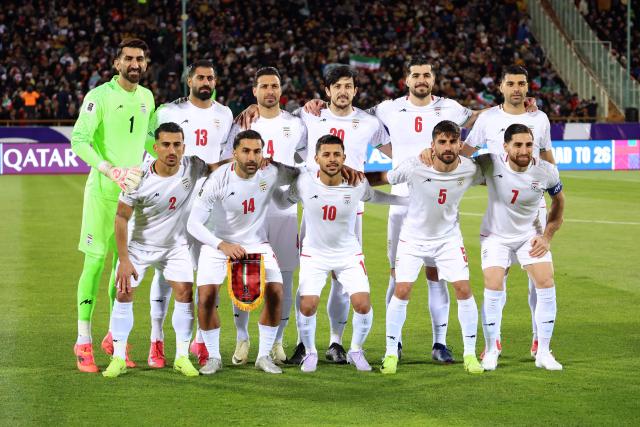 (FILES) Iran's national footbal team pose for a group picture before the FIFA World Cup 2026 Asia zone qualifiers group A football match between Iran and Uzbekistan, on March 25, 2025 in Tehran. The war in the Middle East triggered by US and Israeli strikes on Iran has raised the question of whether the Iranian national team will take part in the 2026 World Cup, during which it is due to play group games in the United States. (Photo by AFP)