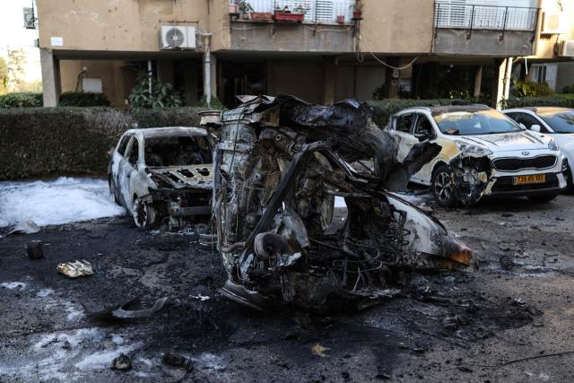 A photograph shows the wreckage of cars at a site struck by a projectile in Ramat Gan near Tel Aviv on March 3, 2026. The Middle East has becomed gripped by a war triggered by US and Israel launched airstrikes against Iran on February 28, that killed the Islamic republic's supreme leader and other officials. (Photo by Ilia YEFIMOVICH / AFP)