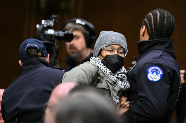 A protestor is removed by US Capitol Police officers as Homeland Security Secretary Kristi Noem testifies during a Senate Judiciary Committee hearing on oversight of the Department of Homeland Security, on Capitol Hill in Washington, DC on March 3, 2026. (Photo by Mandel NGAN / AFP)