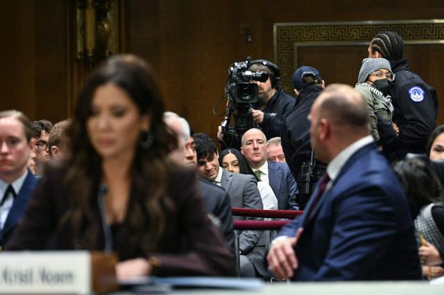 A protestor is removed by a US Capitol Police officer as Homeland Security Secretary Kristi Noem (L) testifies during a Senate Judiciary Committee hearing on oversight of the Department of Homeland Security, on Capitol Hill in Washington, DC on March 3, 2026. (Photo by Jim WATSON / AFP)