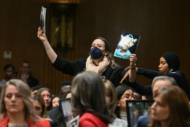 A protestor is removed by a US Capitol Police officer as Homeland Security Secretary Kristi Noem testifies during a Senate Judiciary Committee hearing on oversight of the Department of Homeland Security, on Capitol Hill in Washington, DC on March 3, 2026. (Photo by Jim WATSON / AFP)