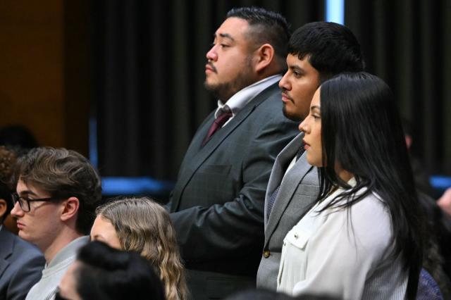 (L/R) Javier Ramirez, Leonardo Garcia Venegas, and Marimar Martinez, American citizens who were previously detained by federal immigration officers, stand as they are recognized by Senator Richard Blumenthal (out of frame), Democrat from Connecticut, as US Homeland Security Secretary Kristi Noem testifies during a Senate Judiciary Committee hearing on oversight of the Department of Homeland Security, on Capitol Hill in Washington, DC on March 3, 2026. (Photo by Mandel NGAN / AFP)