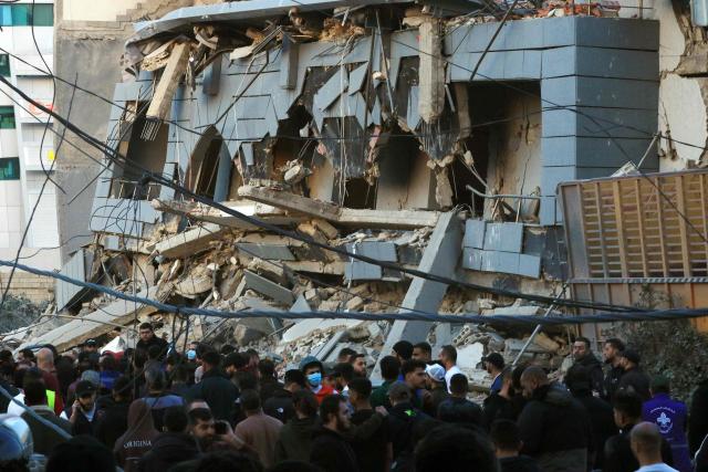 Rescuers gather at the site of an Israeli airstrike that targeted the Jamaa Islamiya offices in the southern Lebanese coastal city of Sidon on March 3, 2026. Israel bombarded Lebanon on March 2, expanding the conflict across the region after the massive Israel-US attack on Iran that the US president launched to topple Tehran's ruling clerics, and killing their supreme leader on February 28. (Photo by Mahmoud ZAYYAT / AFP)