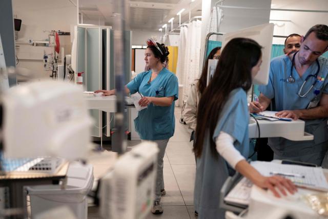 Hospital workers and children don costumes for the Purim celebrations, at Schneider Children Medical Center which established a fortified underground hospital which includes approximately 200 inpatient beds located about 30 meters below ground level, in Petah Tikva, central Israel on March 3, 2026. The United States and Israel launched strikes against Iran on February 28, with the killing of Iran's supreme leader and the Islamic republic retaliated with barrages of missiles at Gulf states and Israel. (Photo by Maya Levin / AFP)