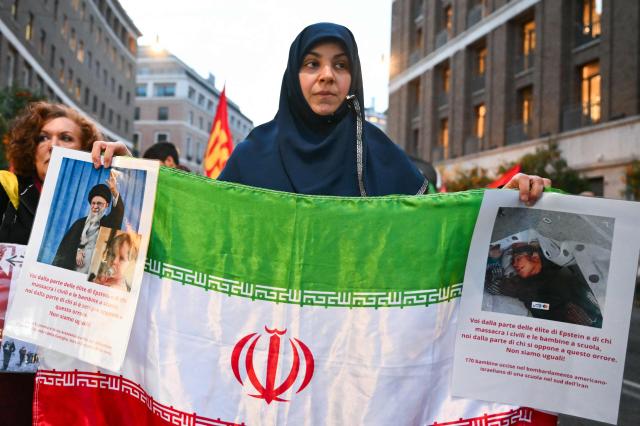 Women hold pictures of assassinated Iranian supreme leader Ayatollah Ali Khamenei and an Iranian flag during a protest against the US and Israel attack of Iran near the US Embassy in Rome, on March 3, 2026. The United States and Israel launched strikes against Iran on February 28, killing Iran's supreme leader and top military leaders, prompting authorities to retaliate with strikes on Israel and across the Gulf. (Photo by Alberto PIZZOLI / AFP)
