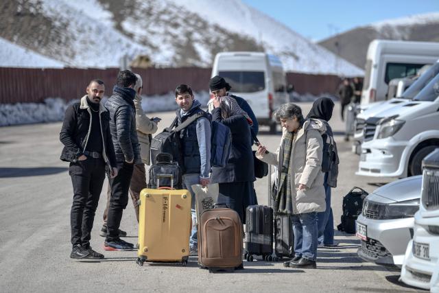 Iranian nationals wait for busses in Turkey after passing through the Razi-Kapiköy border crossing in Van, north-eastern Turkey, on March 3, 2026, a day after Turkey and Iran have mutually suspended day-trip crossings at their border as Israeli-US strikes continued to pound the Islamic Republic. (Photo by Ali IHSAN OZTURK / AFP)
