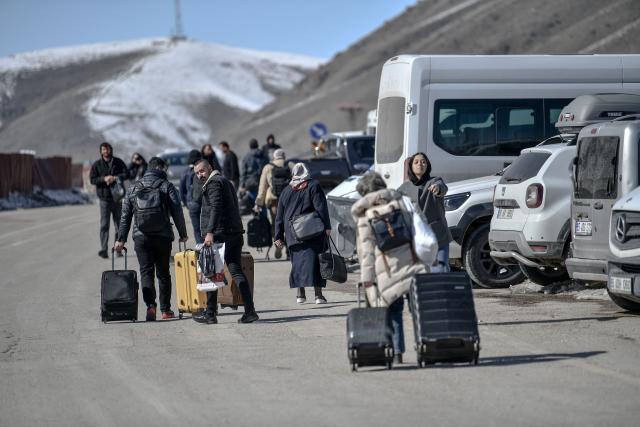 Iranian nationals wait for busses in Turkey after passing through the Razi-Kapiköy border crossing in Van, north-eastern Turkey, on March 3, 2026, a day after Turkey and Iran have mutually suspended day-trip crossings at their border as Israeli-US strikes continued to pound the Islamic Republic. (Photo by Ali IHSAN OZTURK / AFP)